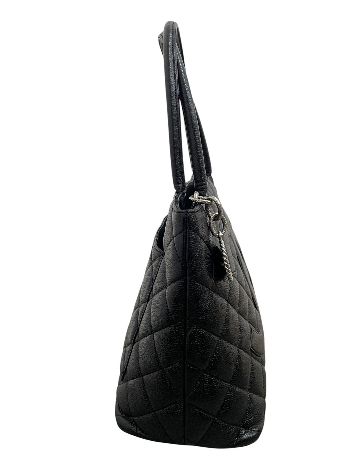 Vista laterale della borsa Chanel Medallion Tote che mostra la struttura a soffietto in pelle Caviar