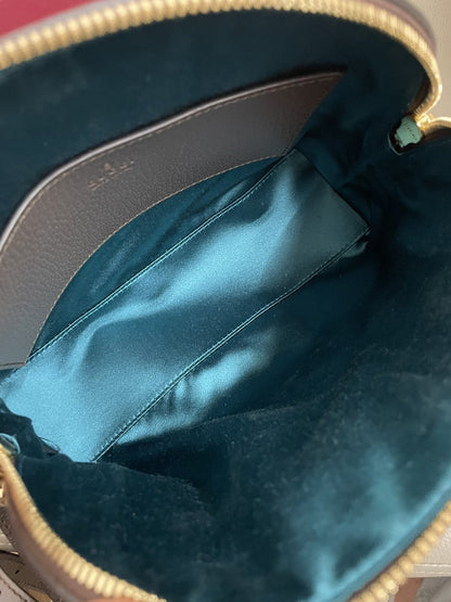 Vista dell'interno della borsa Gucci Ophidia con fodera in raso azzurro e tasca aperta.